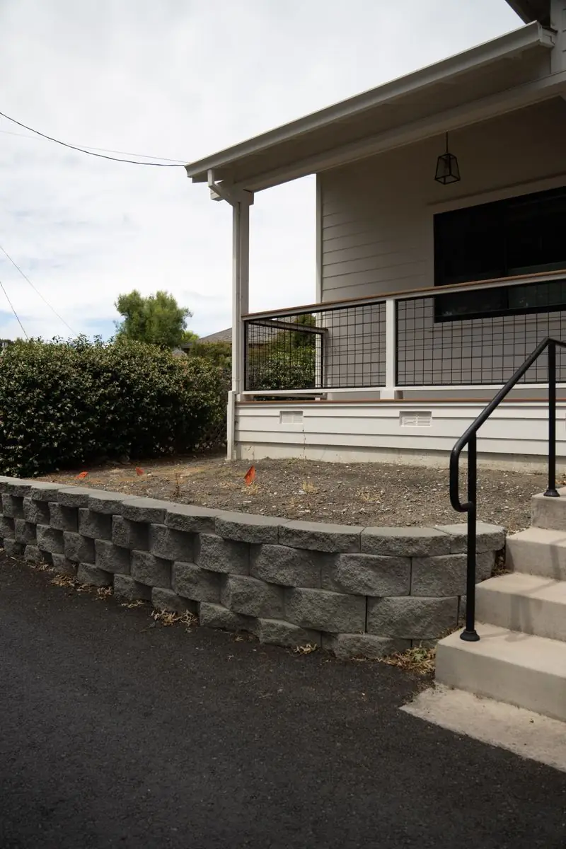 Completed retaining wall, railing and concrete walkway